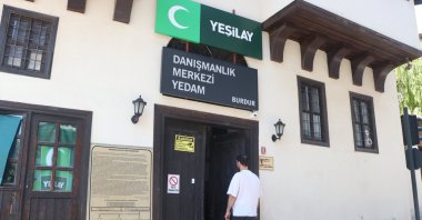 M.B. enters the Green Crescent Counseling Center (YEDAM) building, where he received treatment and now attends workshops, Burdur, Türkiye, Oct. 5, 2025. (AA Photo)