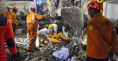 Rescuers recover the body of a victim from the rubble in the aftermath of the collapse at an Islamic boarding school, in Sidoarjo, East Java province, Indonesia, Oct. 6, 2025. (EPA Photo)