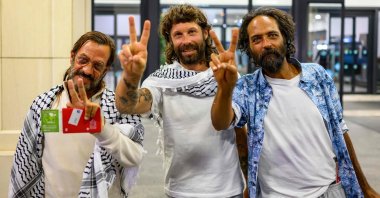 Three of the Swiss activists who were sailing aboard vessels from the Global Sumud Flotilla make the victory sign after arriving in Istanbul, Türkiye, Oct. 4, 2025. (AFP Photo)