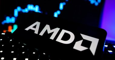 The AMD logo is seen on a screen with a stock market chart in the background, New York, U.S., Sept. 10, 2025. (Shutterstock Photo)