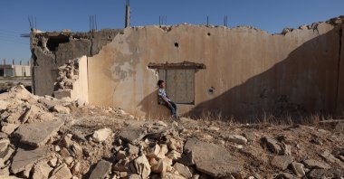 A child is seen in the Manbij district of Aleppo province, Syria, Sept. 11, 2025. (AA Photo)
