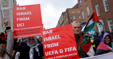 Demonstrators hold placards calling for Israel to be banned from the Union of Cycling International (UCI), UEFA and FIFA global and European soccer, in support of Palestinians during a national protest, in Dublin, Ireland, Oct. 4 2025. (Reuters Photo)