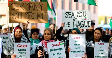 Demonstrators hold posters reading &quot;Gaza is not for Sale&quot; and &quot;Gaza belongs to its people&quot; during a protest titled &quot;Stop the genocide in Gaza&quot; in front of the Foreign Ministry in Berlin, Germany, Oct. 6, 2025. (AFP Photo)