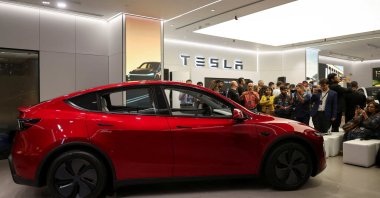 Media personnel take pictures and videos of the Tesla Model Y car at India&#039;s first Tesla showroom in Mumbai, India, July 15, 2025. (Reuters Photo)