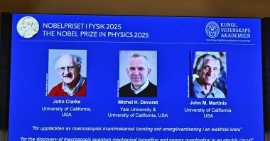 Photos of John Clarke, Michel H Devoret and John M. Martinis are pictured on a screen after they were announced as winners of the Nobel Prize in Physics, at the Nobel Assembly of the Karolinska Institutet, Stockholm, Sweden, Oct. 7, 2025. (AP Photo)