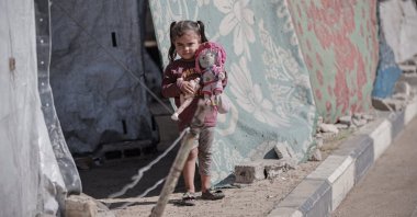 A Palestinian girl stands in front of a tent after being displaced by Israel&#039;s genocidal war in Gaza, Palestine, Oct. 7, 2025. (AA Photo)