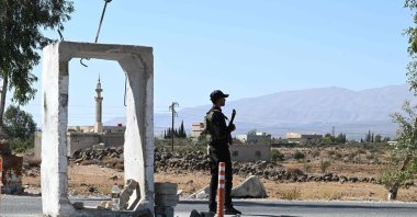 A member of Syria&#039;s security forces stands guard outside a former army base near the city of Quneitra, on the edge of the Israeli-annexed Golan Heights, southern Syria, Sept. 21, 2025. (AFP Photo)