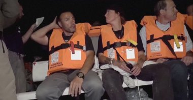The crew of Conscience, a Gaza-bound vessel, sit aboard the boat as they are intercepted by Israeli security forces, Oct. 8, 2025. (Reuters Photo)