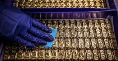 A worker polishes gold bullion bars at the ABC Refinery in Sydney, Australia, Aug. 5, 2020. (AFP Photo)