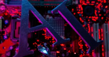 AI letters and robot hand are placed on computer motherboard in this illustration created on June 23, 2023. (Reuters Photo)