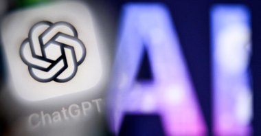 This file photo shows the letters AI for Artificial Intelligence on a laptop screen (R) next to the logo of the ChatGPT application on a smartphone screen in Frankfurt am Main, western Germany, Sept. 1, 2025. (AFP Photo)