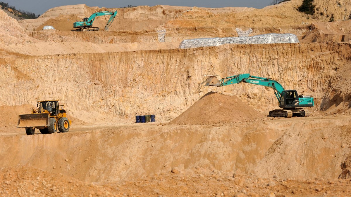 Workers use machinery to dig at a rare earth mine in the Ganxian county, Jiangxi, central China, Dec. 30, 2010. (AP Photo)