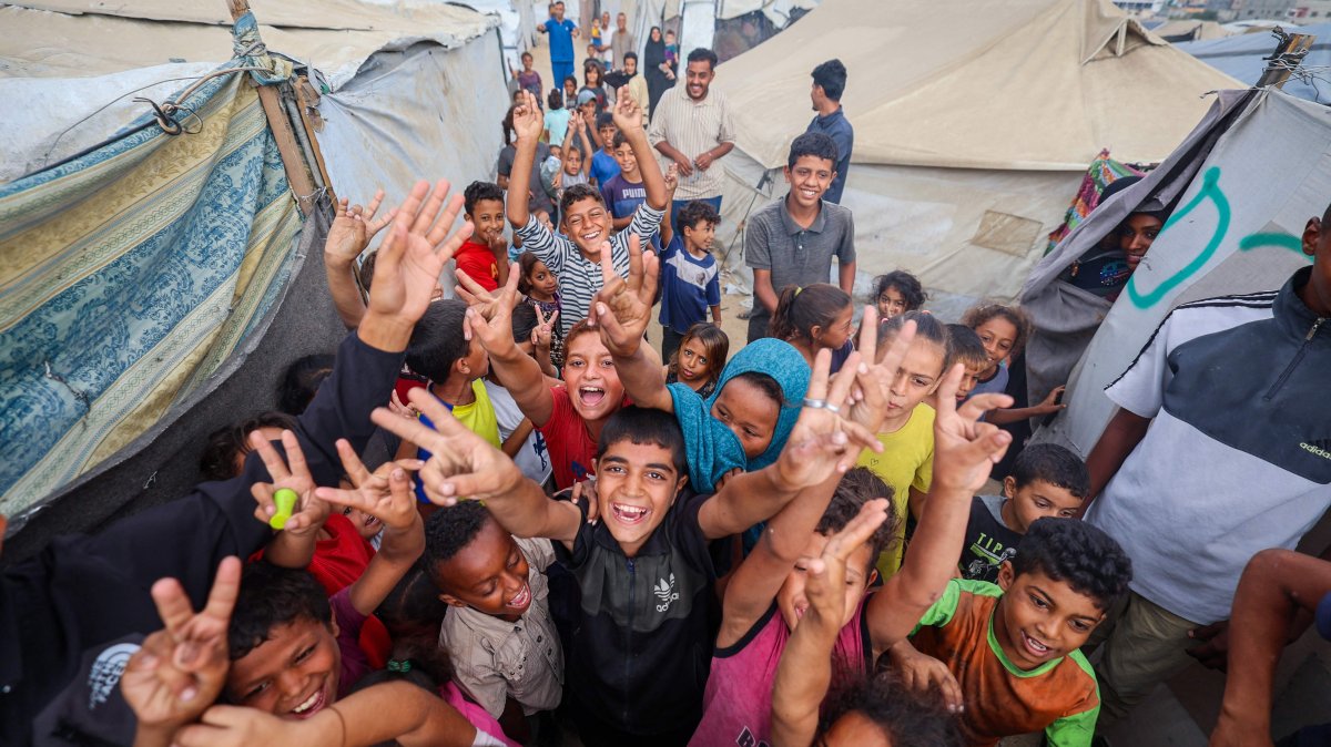 Palestinian children celebrate at a camp in Nuseirat, Gaza Strip, Palestine, Oct. 9, 2025. (AFP Photo)