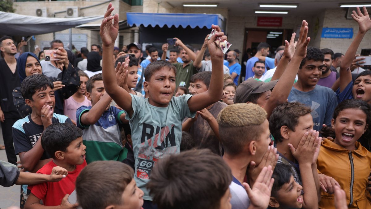 Palestinian children celebrate outside Deir al-Balaah&#039;s Shuhada al-Aqsa hospital in the central Gaza Strip, Palestine, Oct. 9, 2025. (AFP Photo)