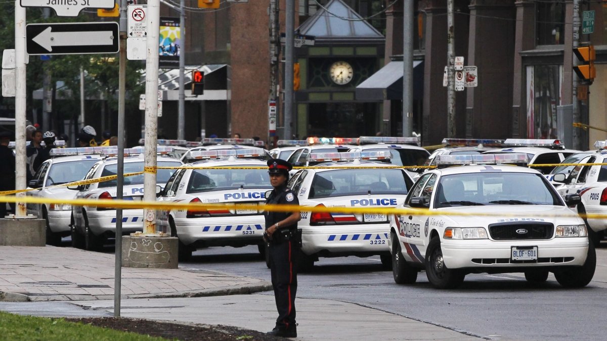 A police officer stands in front of police cars at the Toronto Eaton Centre shopping mall in Toronto, Canada, June 2, 2012. (Reuters File Photo)