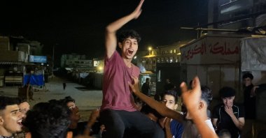 Palestinians celebrate following news of a new Gaza cease-fire deal, in Khan Yunis, southern Gaza Strip, Palestine, Oct. 9, 2025. (AFP Photo)