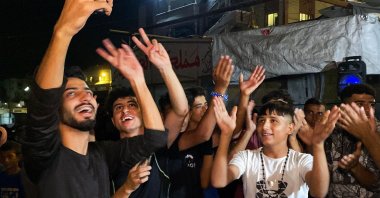Palestinians celebrate following the news of a Gaza cease-fire deal, in Khan Younis, Oct. 9, 2025. (AFP Photo)