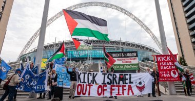 Pro-Palestinian activists protest outside Wembley Stadium to demand that the Football Association issue a public statement calling for the Israeli Football Association (IFA) to be suspended from participation in UEFA and FIFA tournaments, London, U.K., Oct. 2, 2025. (Getty Images Photo)