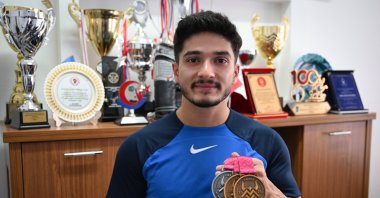 Turkish weightlifter Muhammed Furkan Özbek poses for a photo with his medals, Ankara, Türkiye, Oct. 8, 2025. (AA Photo)