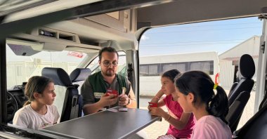 Children take part in art and play activities inside a Turkish Green Crescent (Yeşilay) caravan set up in a container city, Hatay, Türkiye, Oct. 9, 2025. (AA Photo)