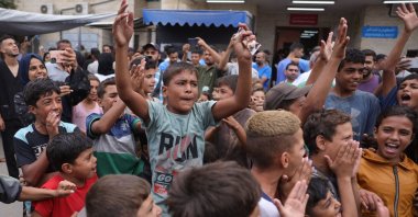 Palestinian children celebrate outside Deir al-Balaah&#039;s Shuhada al-Aqsa hospital in the central Gaza Strip, Palestine, Oct. 9, 2025. (AFP Photo)