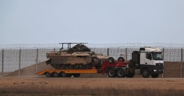 An Israeli military truck carrying APCs leaving the Gaza Strip after the Trump announcement on the Israel-Hamas agreement on the first phase of a Gaza peace plan, Oct. 9, 2025. (EPA Photo)