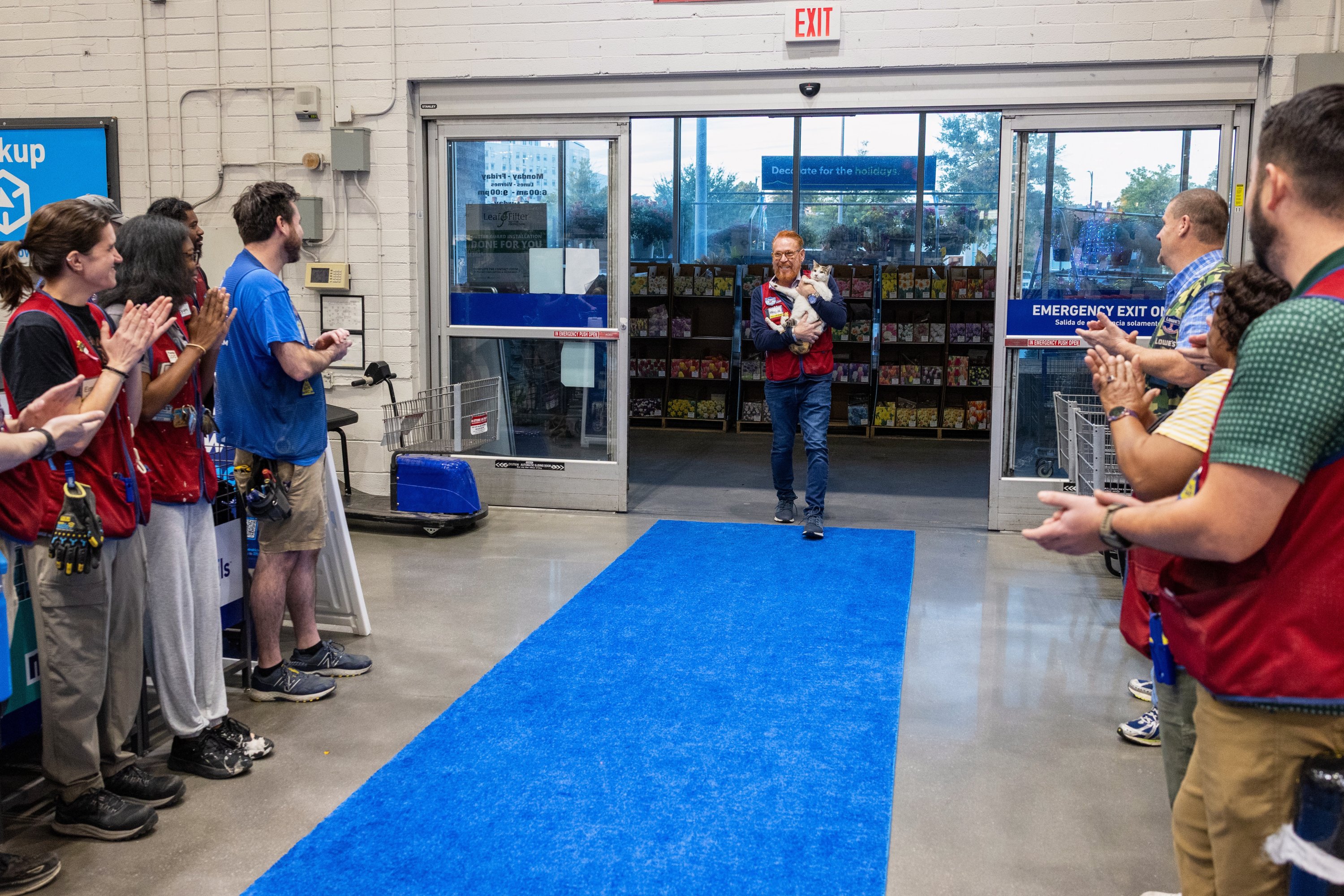 In this photo provided by Lowe's, employees welcome back Francine, the store cat, after she disappeared unexpectedly in Richmond, Virginia, U.S., Oct. 7, 2025. (AP Photo)