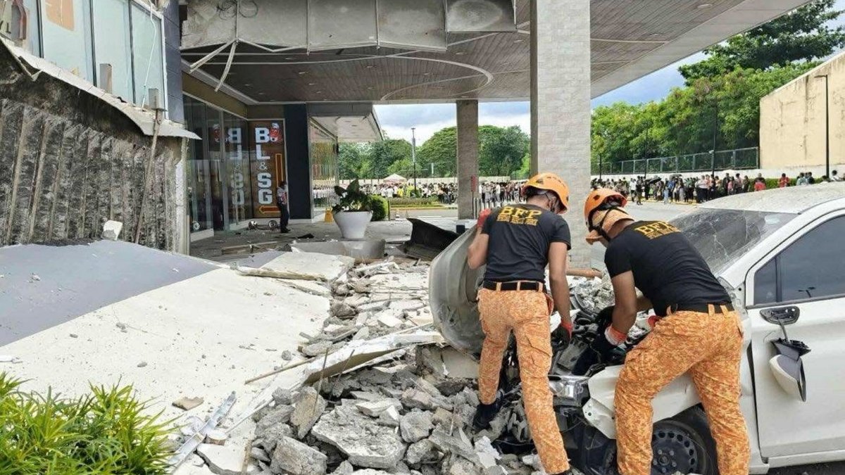 A handout photo made available by the Bureau of Fire Protection (BFP) shows fire officers removing debris outside a shopping mall following an earthquake, Butuan, Philippines, Oct. 10, 2025. (EPA Photo)
