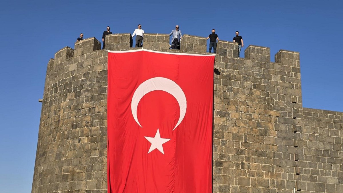 A giant Turkish flag hangs on the ancient city walls of Diyarbakır, where the PKK was founded years ago, southeastern Türkiye, July 12, 2025. (AA Photo)