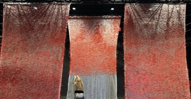 A woman writes the names of Palestinian children killed in Gaza during a vigil, Oslo, Norway, Oct. 9, 2025. (AA Photo)