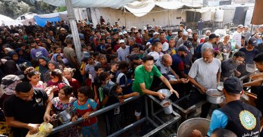 Palestinians gather to receive food from a charity kitchen in Nuseirat, central Gaza Strip, Oct. 7, 2025. (Reuters File Photo)