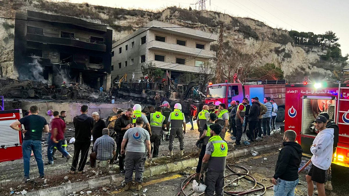 Rescuers and first-responders stand outside a damaged building following an overnight Israeli strike in Al-Msayleh area in southern Lebanon, Oct. 11, 2025. (AFP Photo)