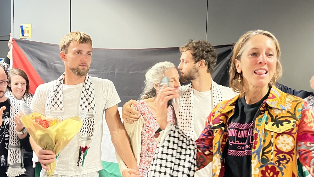 Adnaan and Tor Stumo, American brothers who joined the Global Sumud Flotilla, are greeted with cheers upon their return to the United States after days spent in Israeli detention, at Dulles Airport, Washington D.C., U.S., Oct. 10, 2025. (AA Photo)