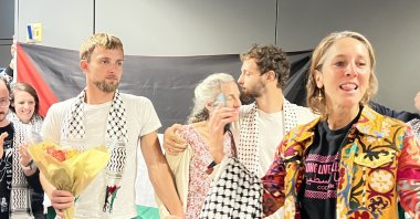 Adnaan and Tor Stumo, American brothers who joined the Global Sumud Flotilla, are greeted with cheers upon their return to the United States after days spent in Israeli detention, at Dulles Airport, Washington D.C., U.S., Oct. 10, 2025. (AA Photo)