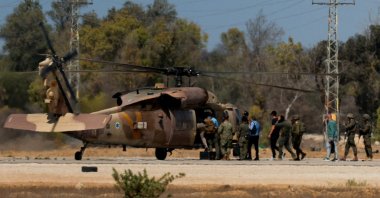 U.S. Special Envoy to the Middle East Steve Witkoff and others board an Israeli black hawk helicopter from Reim military base, where the Israeli hostages are expected to arrive after their release, amid a ceasefire between Israel and Hamas in Gaza, in southern Israel, Oct. 11, 2025. (Reuters Photo)