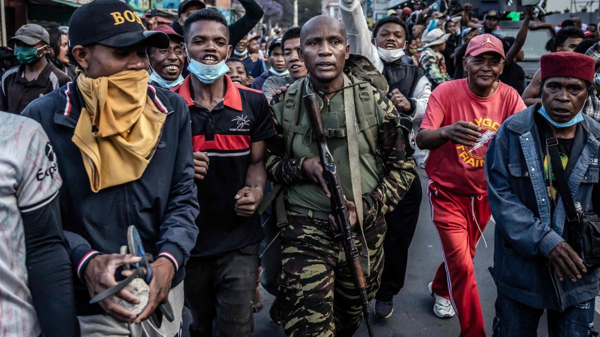 A member of a section of the Malagasy army walks surrounded by protesters in Antananarivo, Madagascar, Oct. 11, 2025. (AFP Photo)