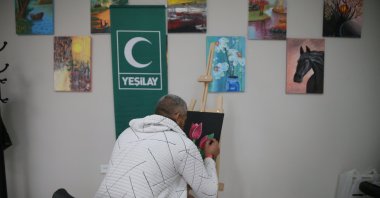 K.Ş. paints during a recovery activity at the Green Crescent Counseling Center (YEDAM), Niğde, Türkiye, Oct. 12, 2025. (AA Photo)