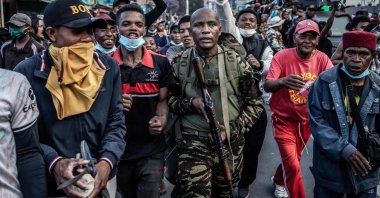 A member of a section of the Malagasy army walks surrounded by protesters in Antananarivo, Madagascar, Oct. 11, 2025. (AFP Photo)