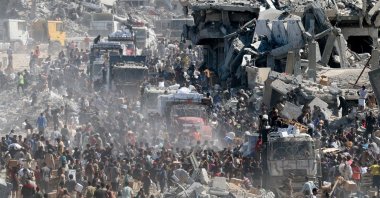 Palestinians collect aid supplies from trucks that entered Gaza, Palestine, Oct. 12, 2025. (Reuters Photo)