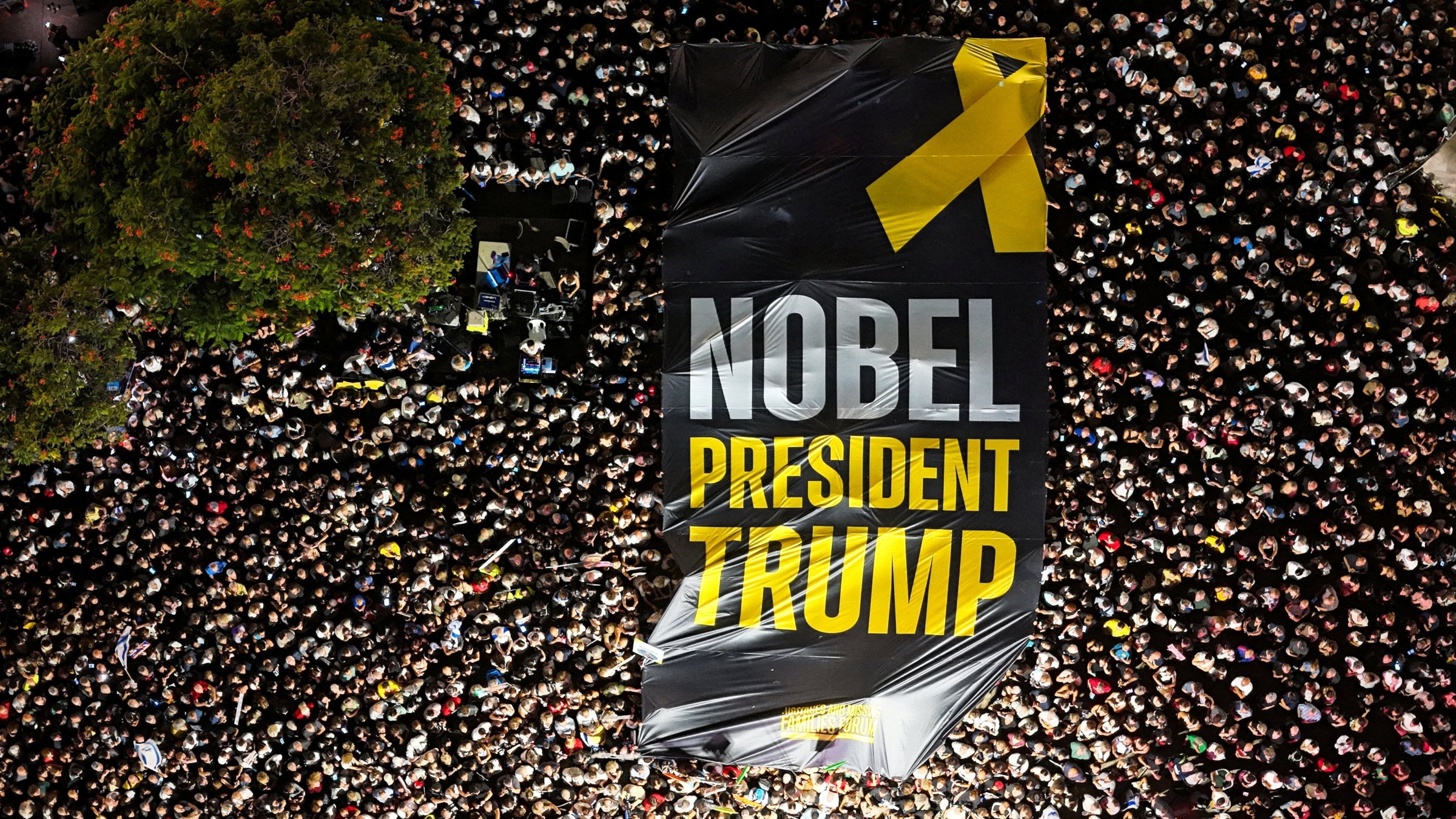 A drone photo of people gathering in &quot;Hostages square&quot; as they hold up a giant sign with the words &quot;Nobel President Trump&quot; written on it, after a cease-fire between Israel and Hamas in Gaza went into effect, Tel Aviv, Israel, Oct.11, 2025. (Reuters Photo)