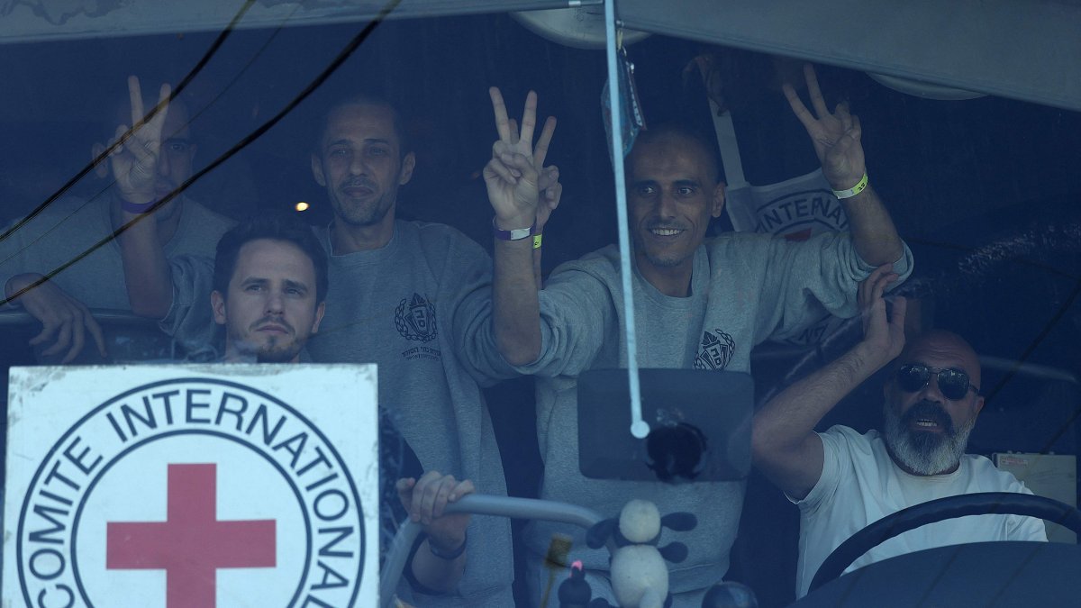 Palestinian men gesture from inside a bus after being released from the Ofer military prison located between Ramallah and Beitunia in the occupied West Bank, Palestine, Oct. 13, 2025. (AFP Photo)