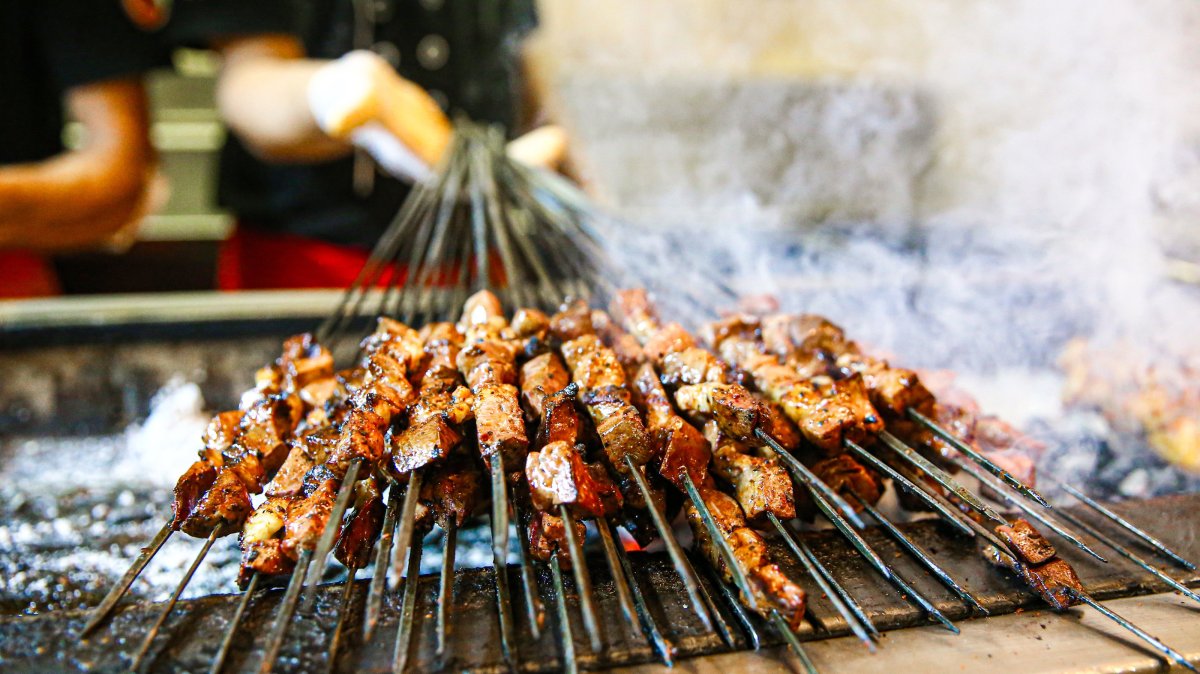 Adana kebabs sizzle on a traditional charcoal grill, Adana, Türkiye, Oct. 4, 2025. (AA Photo)