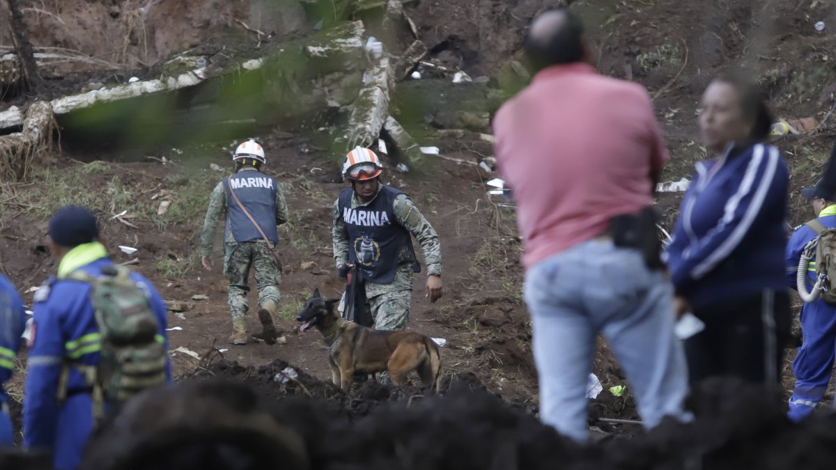 Members of the Mexican Navy patrol an area affected by heavy rains remove mud from their homes in Huauchinango, Mexico, Oct. 12, 2025. (EPA Photo)