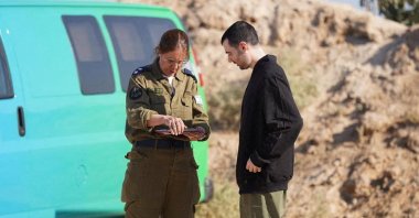 Released Israeli hostage Guy Gilboa-Dalal, speaks with a representative of the Israeli army after being released, as part of a prisoner-hostage swap and a cease-fire deal between Israel and Hamas, Reim, Israel, Oct. 13, 2025. (Reuters Photo)