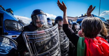 Police officers stand guard as people participate in a rally calling for the release of the Global Sumud Flotilla, which was heading to Gaza with humanitarian aid, Naples, Italy, Oct. 3, 2025. (EPA Photo)
