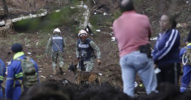 Members of the Mexican Navy patrol an area affected by heavy rains remove mud from their homes in Huauchinango, Mexico, Oct. 12, 2025. (EPA Photo)