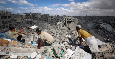Palestinians search the rubble of buildings amid widespread destruction due to Israeli bombardment in Khan Yunis in the southern Gaza Strip, as a cease-fire holds, Oct. 12, 2025. (AFP Photo)