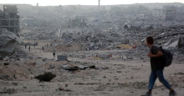 Palestinians make their way past destroyed buildings in Gaza City, Oct. 12, 2025. (AFP Photo)