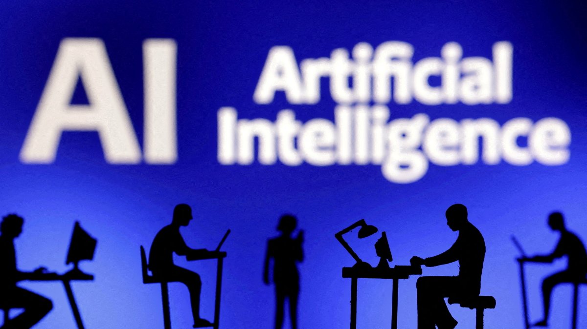 Figurines with computers and smartphones are seen in front of the words &quot;Artificial Intelligence AI&quot; in this illustration created on Feb. 19, 2024. (Reuters Photo)