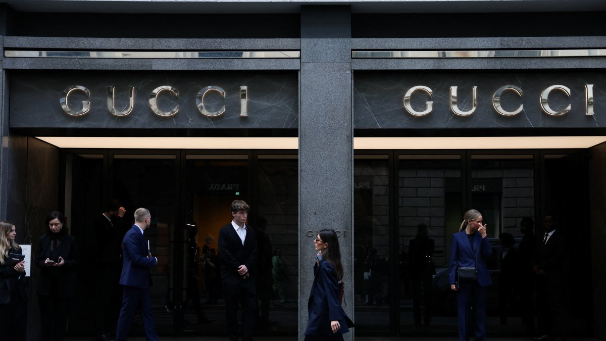 A woman walks past a Gucci store in Milan, Italy, Sept. 24, 2025. (Reuters Photo)
